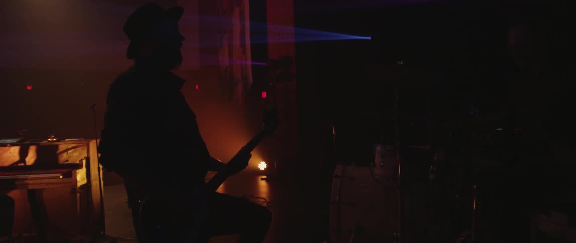 Man playing guitar in dimly lit room