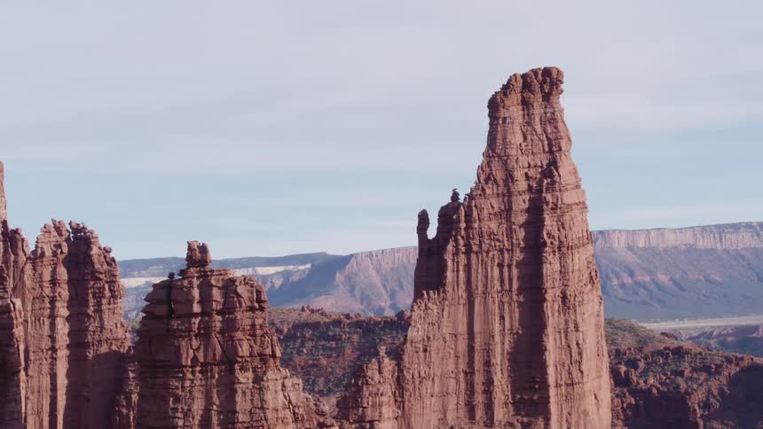 Tall rock formations with mountains in the distance