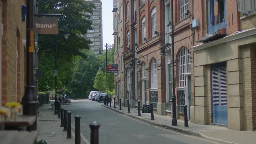 A single person walks at the end of this city street