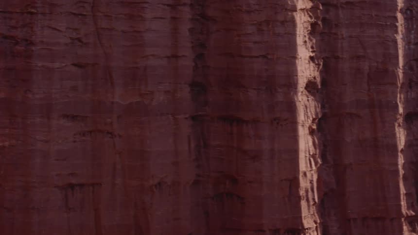 Tall rock formations with mountains in the distance