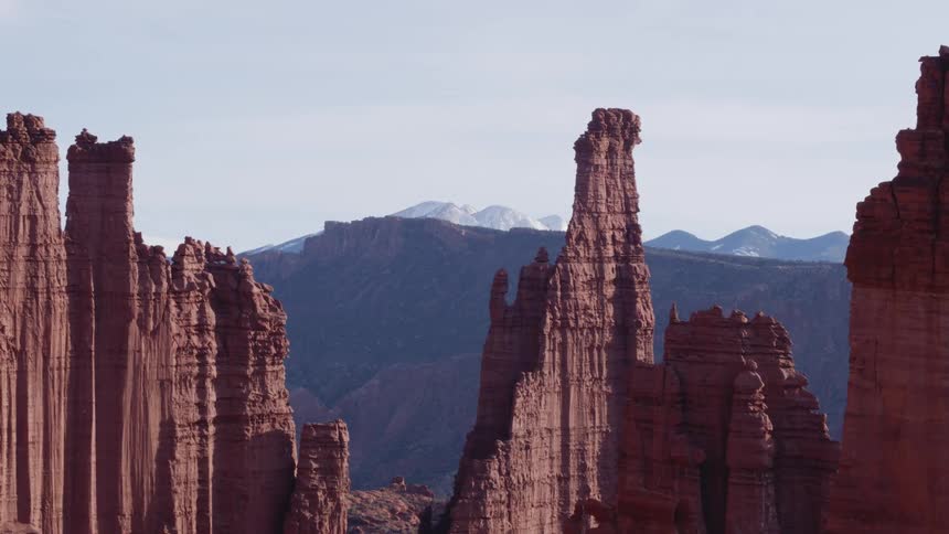 Tall rock formations high in the sky and mountains in the distance