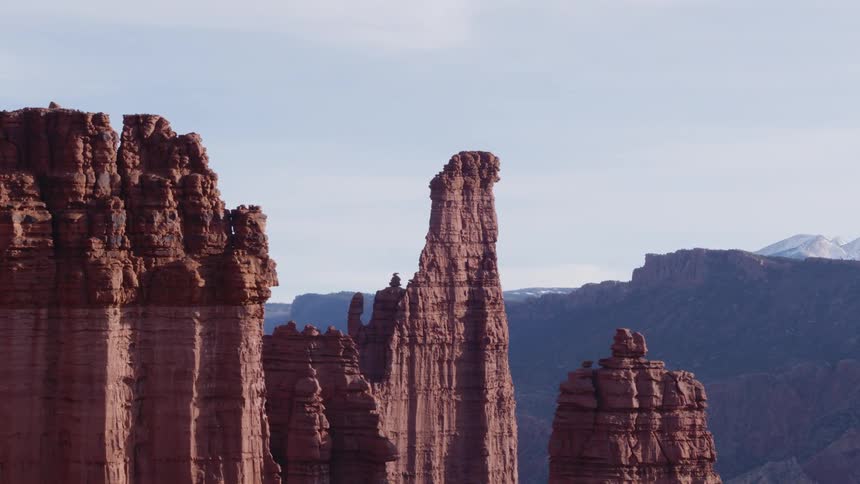 Tall rock formations high in the sky and mountains in the distance