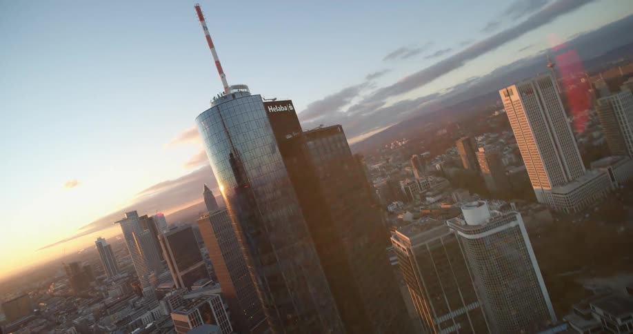 Aerial twisting view of skyscrapers on the city skyline at sunset