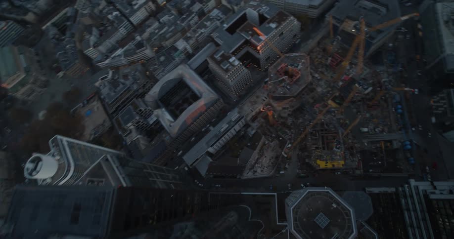 Construction cranes jut out from a large construction site in the heart of downtown