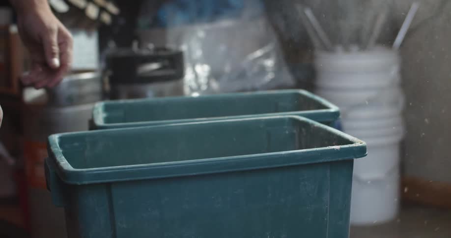 A view of someone sitting down a bucket in a room