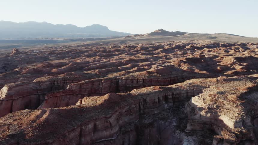 Mountain rock formations and a mountain range in the distance