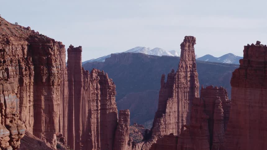 Tall rock formations high in the sky and mountains in the distance