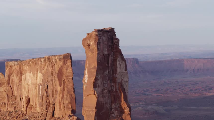 Tall rock formations sit above the wide valley in a canyon