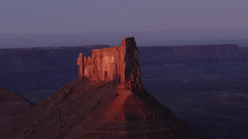 Aerial view of canyons at dusk is displayed