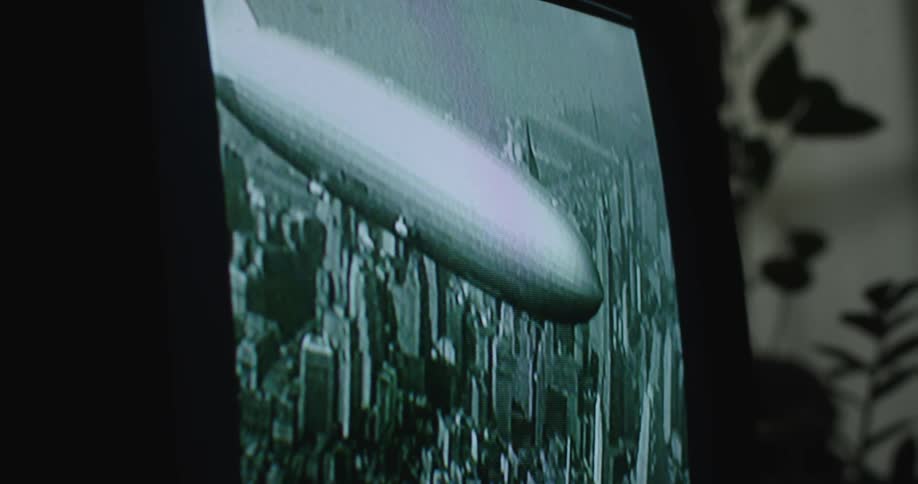 Close up of a television screen showing vintage footage of the hindenburg zeppelin