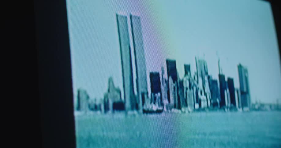 A television with a skyline in front of water on the screen
