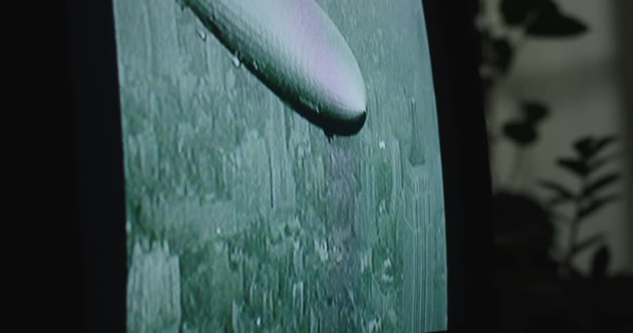 Close up of a television screen showing vintage news about the hindenburg zeppelin