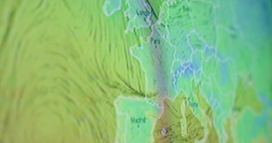 The monitor shows a map with swirling lines