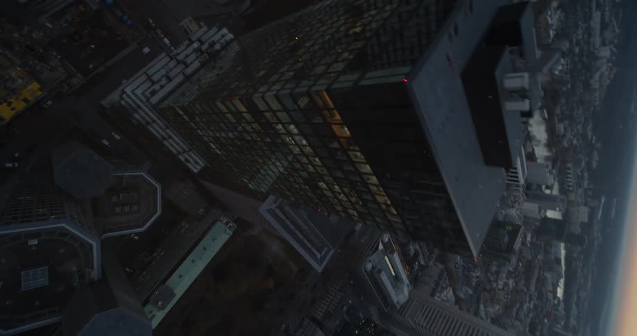 Twisting aerial view of a downtown city at dusk