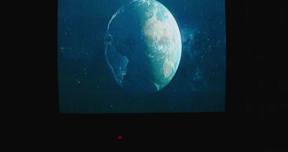 An image of earth plays on a movie screen