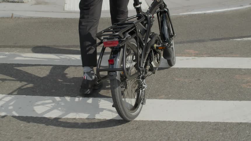 Person pushing bicycle