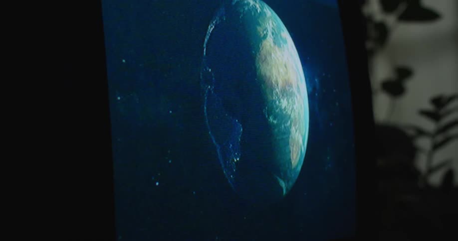 The television is displaying the earth from space