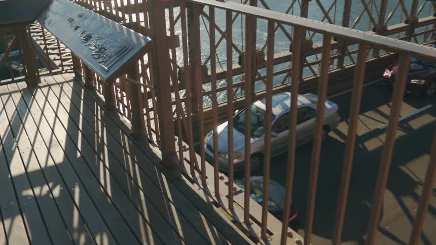 Vehicles cross a busy bridge leading out of downtown