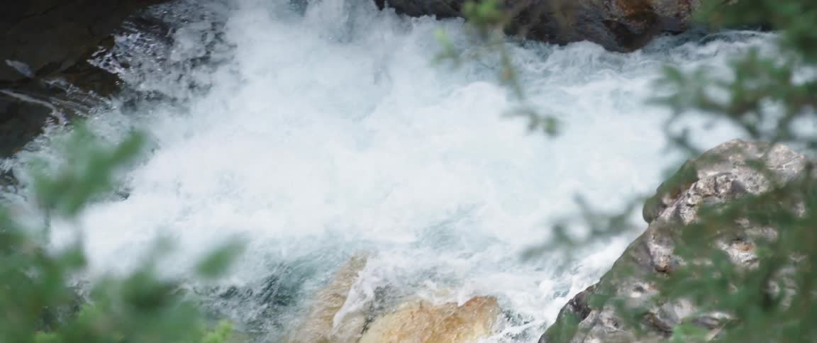Small waterfall bubbling over the rocks on a river in the forest
