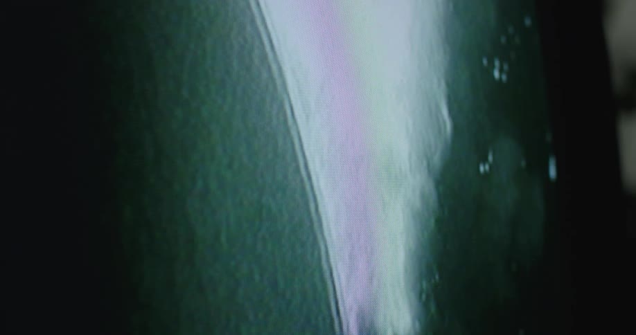 The television is showing a blimp burning in the air