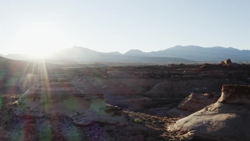 The sun is rising on the canyon