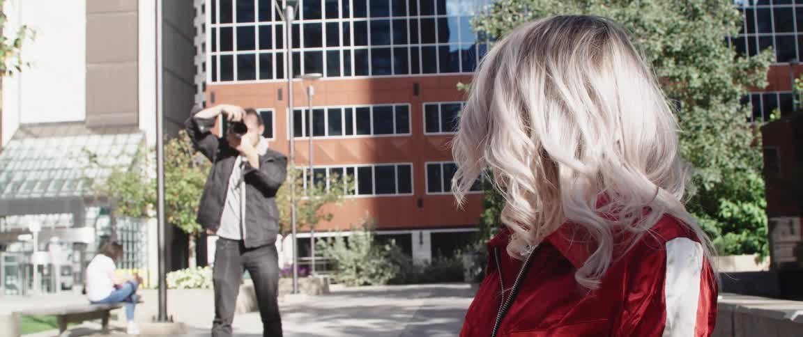 A view of a man taking a photo of a woman