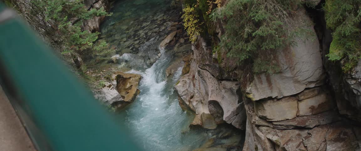 River flowing at the bottom of a ravine seen from a bridge