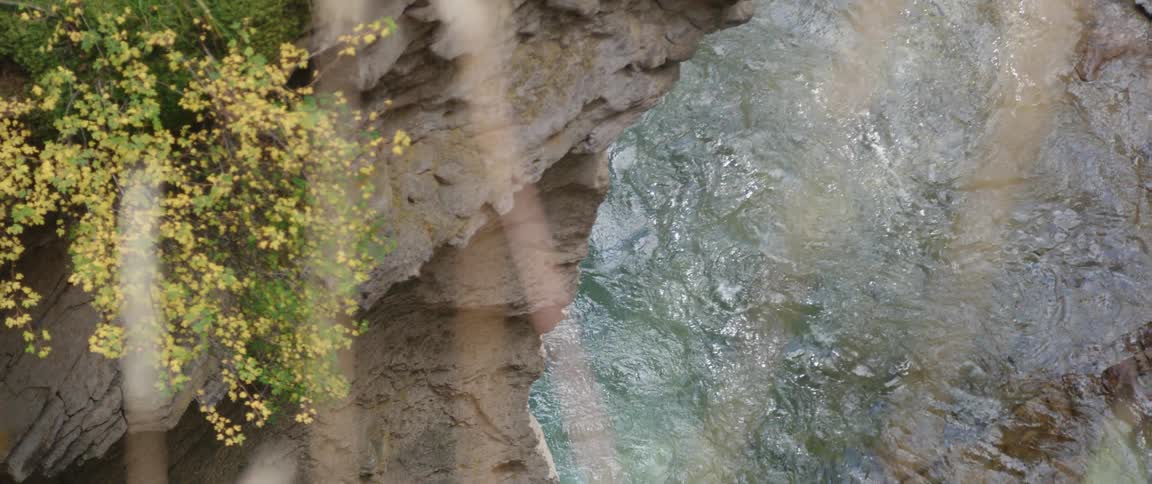 An aerial view of a river below a canyon