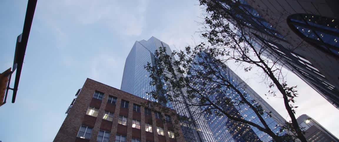 The tall buildings are lit up during the day