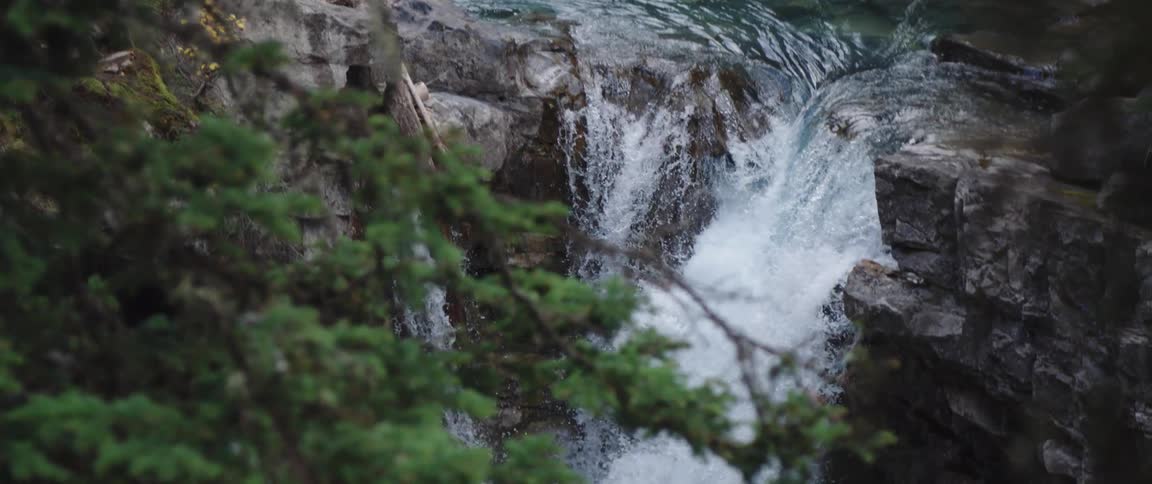 The water travels down the waterfall into the stream