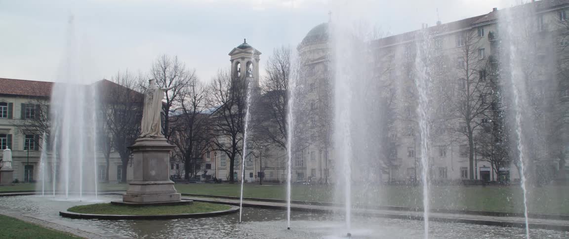The statue sits in the middle of the active fountain