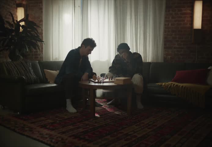 Friends playing chess in a dark living room