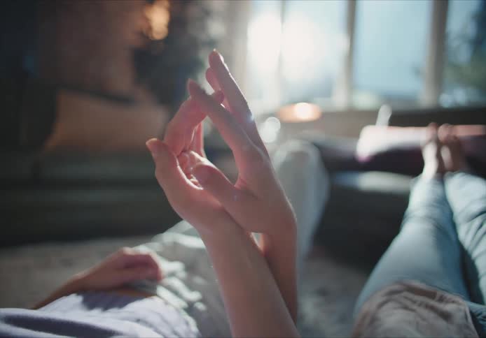 A couple hold hands under the sunlight inside