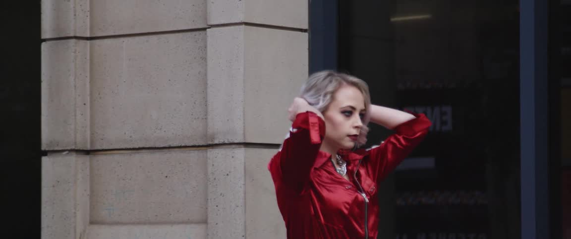 A woman walks past the building