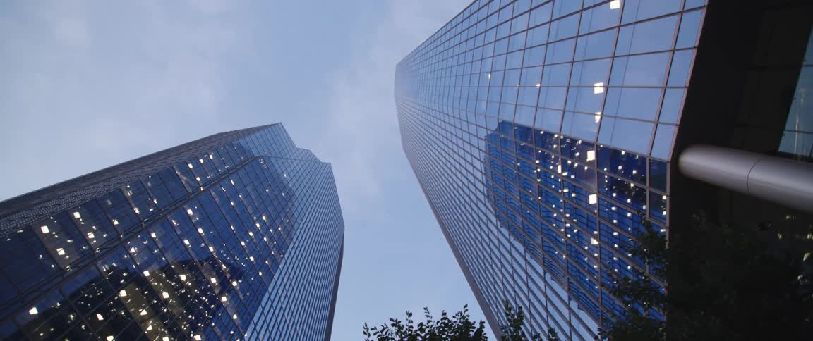 Glass facade of tall skyscrapers in the city skyline at morning