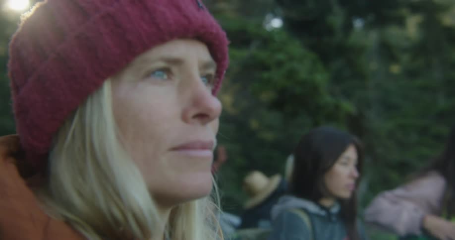 Women are gathered around by the forest