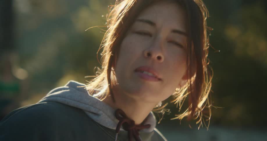 A woman looks around on a sunny day