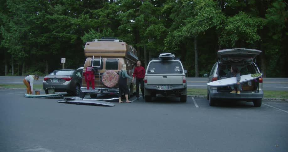 Friends greet and hug in the parking lot