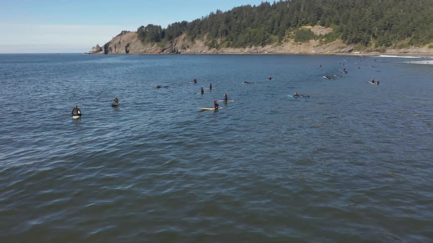 A group of people on surf boards in the water