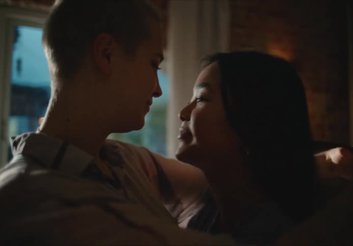 Two women slow dance and cuddle at home