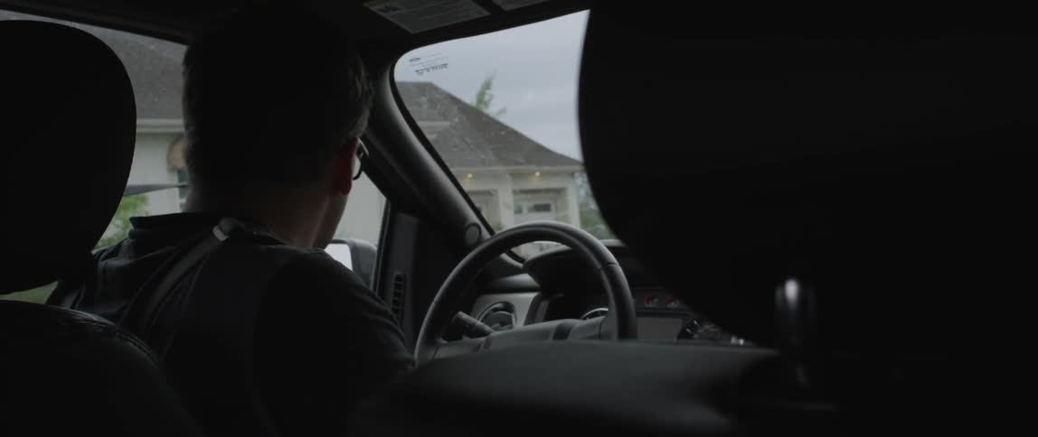 A man parks a car and gets out