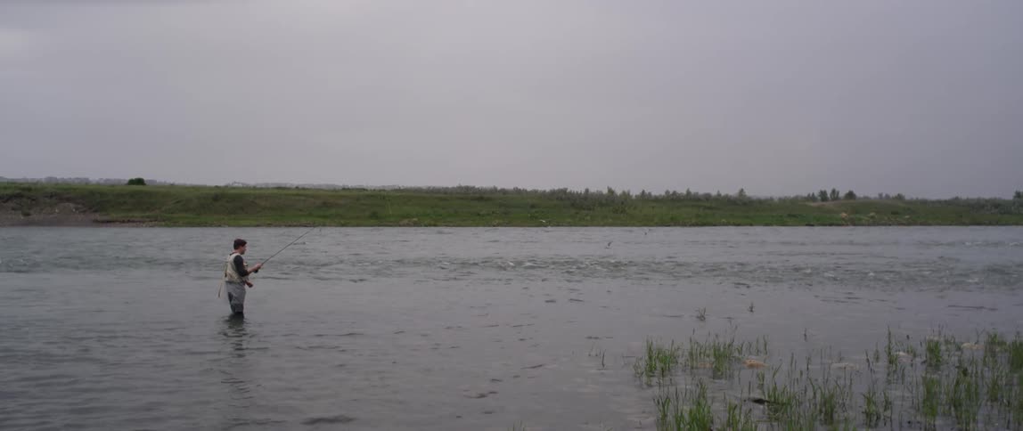 A man is fishing in a river