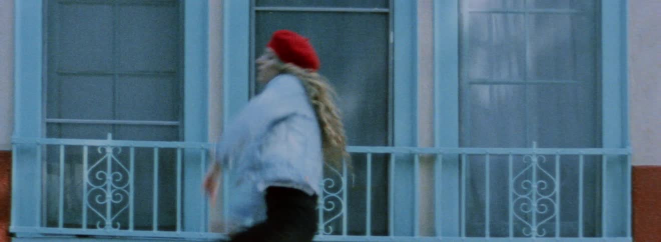 A woman is dancing past the house