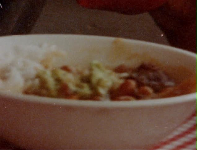 Close up of man eating meal from bowl with vegetables and rice in restaurant
