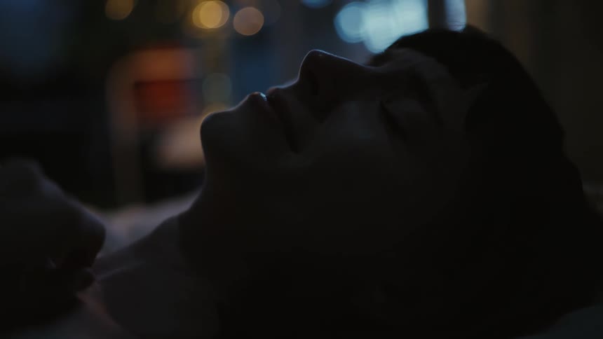A woman is resting in the dark room