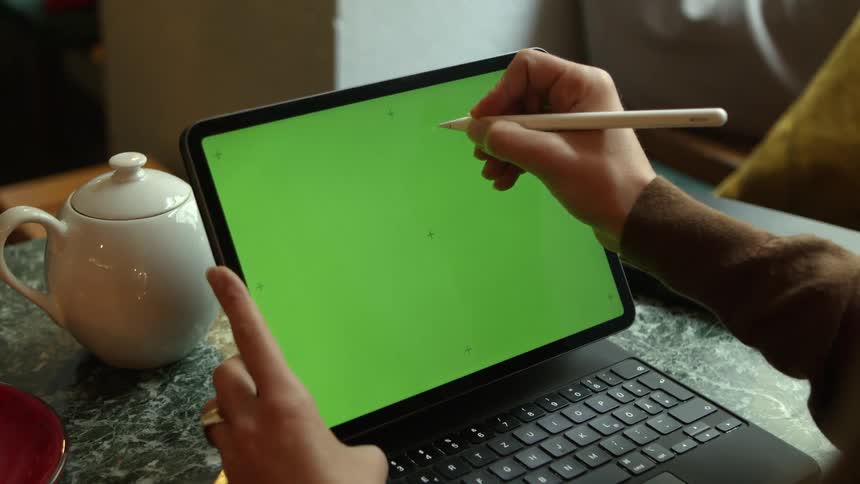 A person is drawing with a stylus