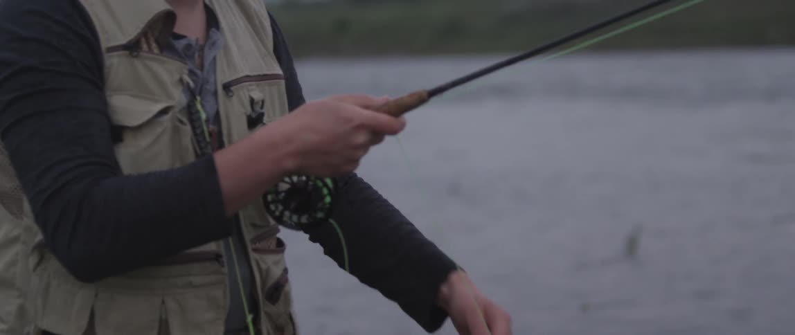 A man untangles his fishing line