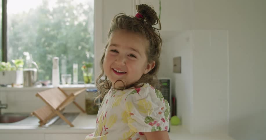 A portrait of a little girl in a room