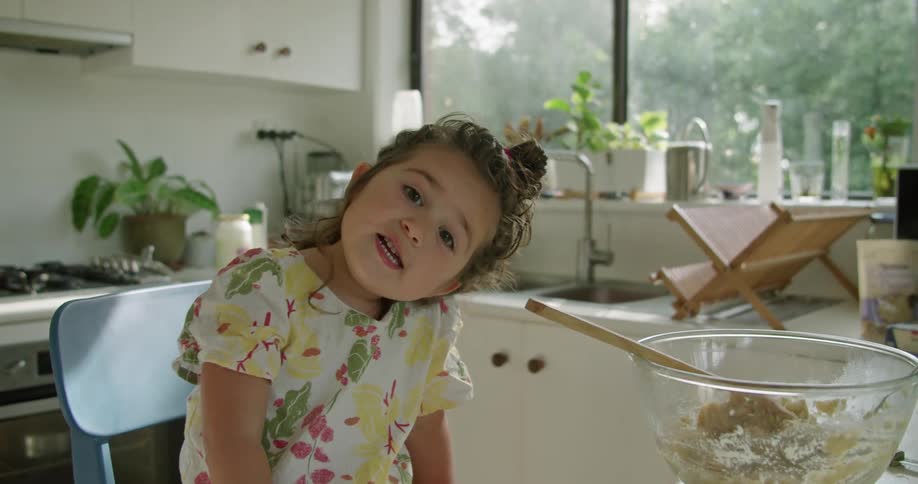 A mother and daughter cooking in a kitchen