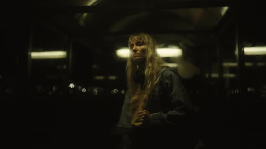 A woman is standing outside the window looking in